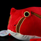 Detail shot of tomato frog plush’s eye and stripe pattern, emphasizing intricate and realistic craftsmanship