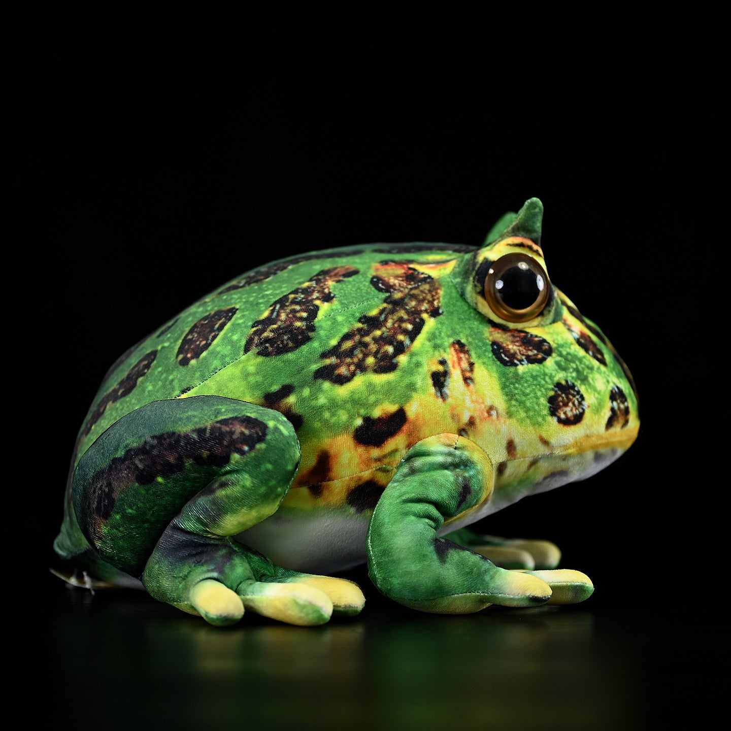 Side view of Pacman Frog Plush with detailed patterns, resembling the Argentine horned frog's unique design