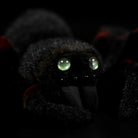 Close-up of Mexican Giant Red Knee Tarantula plush's glowing eyes and detailed face, perfect for spider lovers