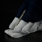 Close-up of the plush tail of a Black-crowned Night Heron toy, showcasing soft gray and black textures
