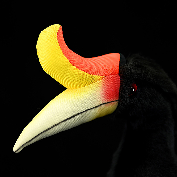 Close-up of the Rhinoceros Hornbill plush toy head by SoftDaysLab, highlighting its vibrant orange and yellow casque
