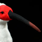 Close-up of Asian crested ibis plush toy's detailed curved black and red beak, designed for true-to-life appearance