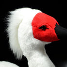 Close-up of the soft and fluffy head of the Asian crested ibis plush, highlighting lifelike red face and texture