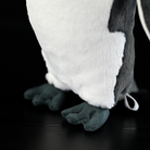 Close-up of king penguin plush feet, showcasing realistic design with soft and durable stitching