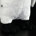 Close-up of African Penguin plush toy’s feet, highlighting soft material and lifelike design