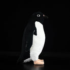 Side view of Adélie penguin plush, highlighting realistic features and soft texture