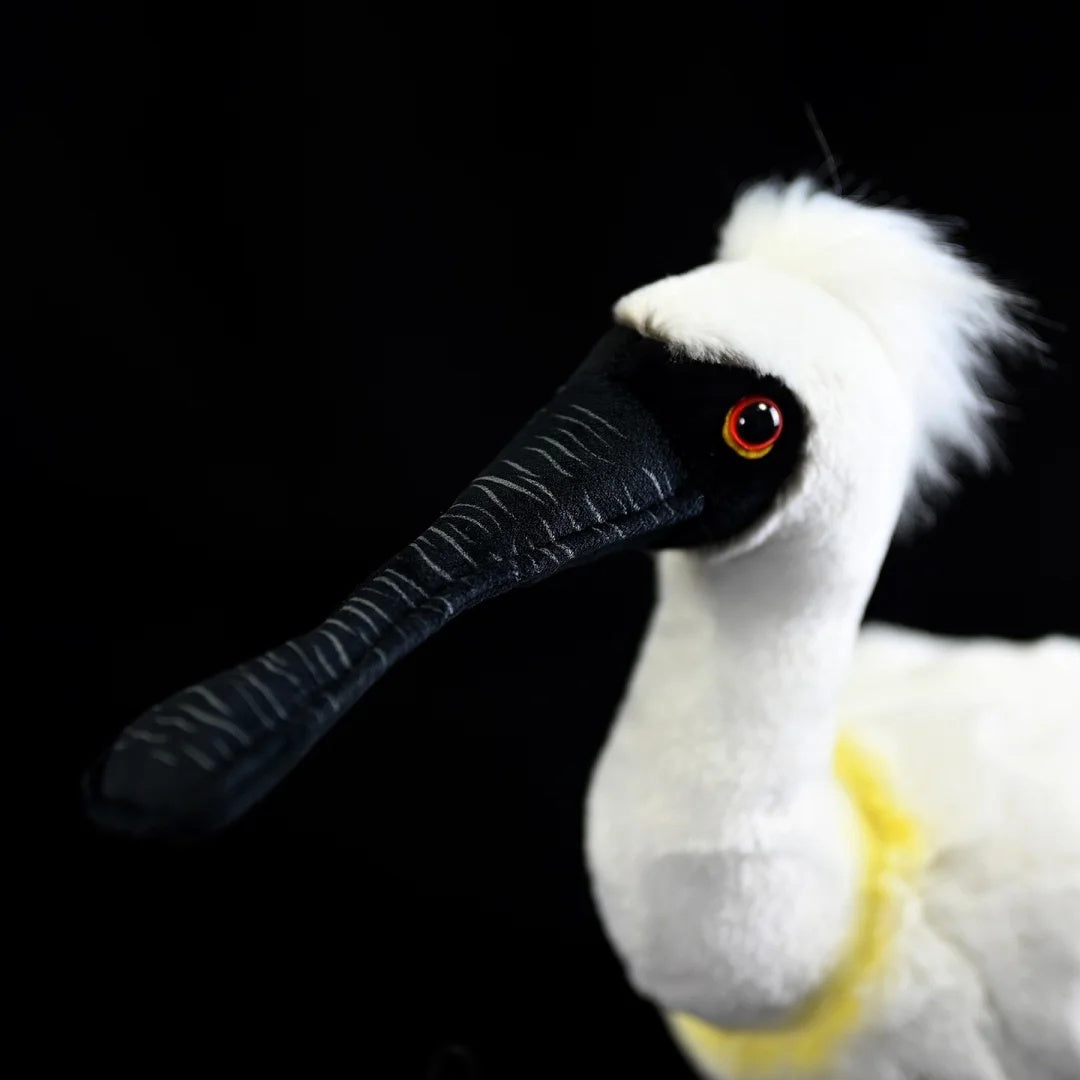 Close-up of the head of the Black-faced Spoonbill Plush Toy emphasizing its striking red eyes and black bill