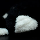 Fluffy white feather detail on ostrich plush toy, mimicking the natural texture of a real ostrich