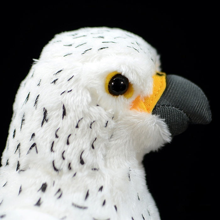 Side close-up showing the lifelike head and beak of a white gyrfalcon plush toy by SoftDaysLab