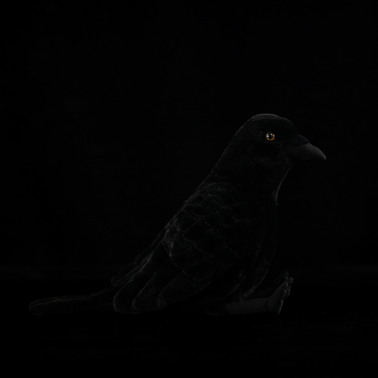 Side view of American crow plush toy, highlighting intricate feather patterns and realistic craftsmanship