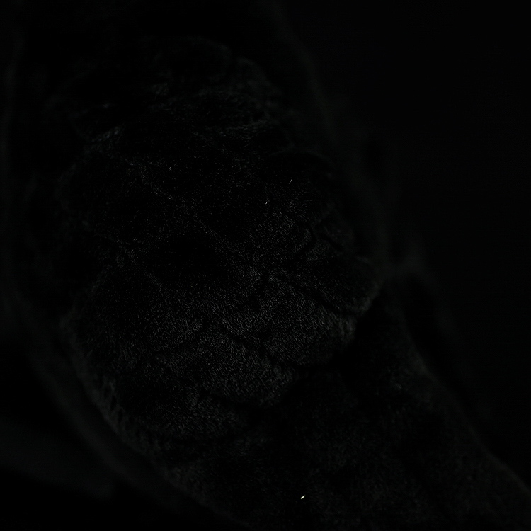 Detailed view of the plush toy’s textured wing, reflecting the realistic design of an American crow