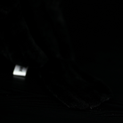 Close-up of the realistic tail of the American crow plush toy, crafted from soft, high-quality fabric