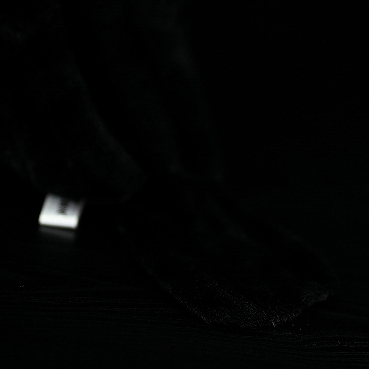 Close-up of the realistic tail of the American crow plush toy, crafted from soft, high-quality fabric