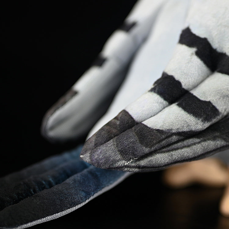 Detailed shot of Hill Pigeon plush wing feathers, showcasing intricate patterns and premium stitching