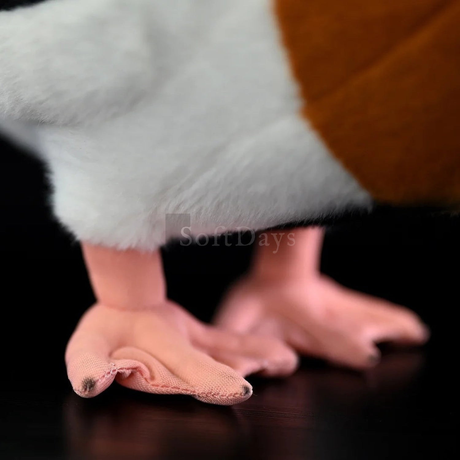 Close-up of common shelduck stuffed toy’s soft orange feet, showcasing intricate and realistic craftsmanship