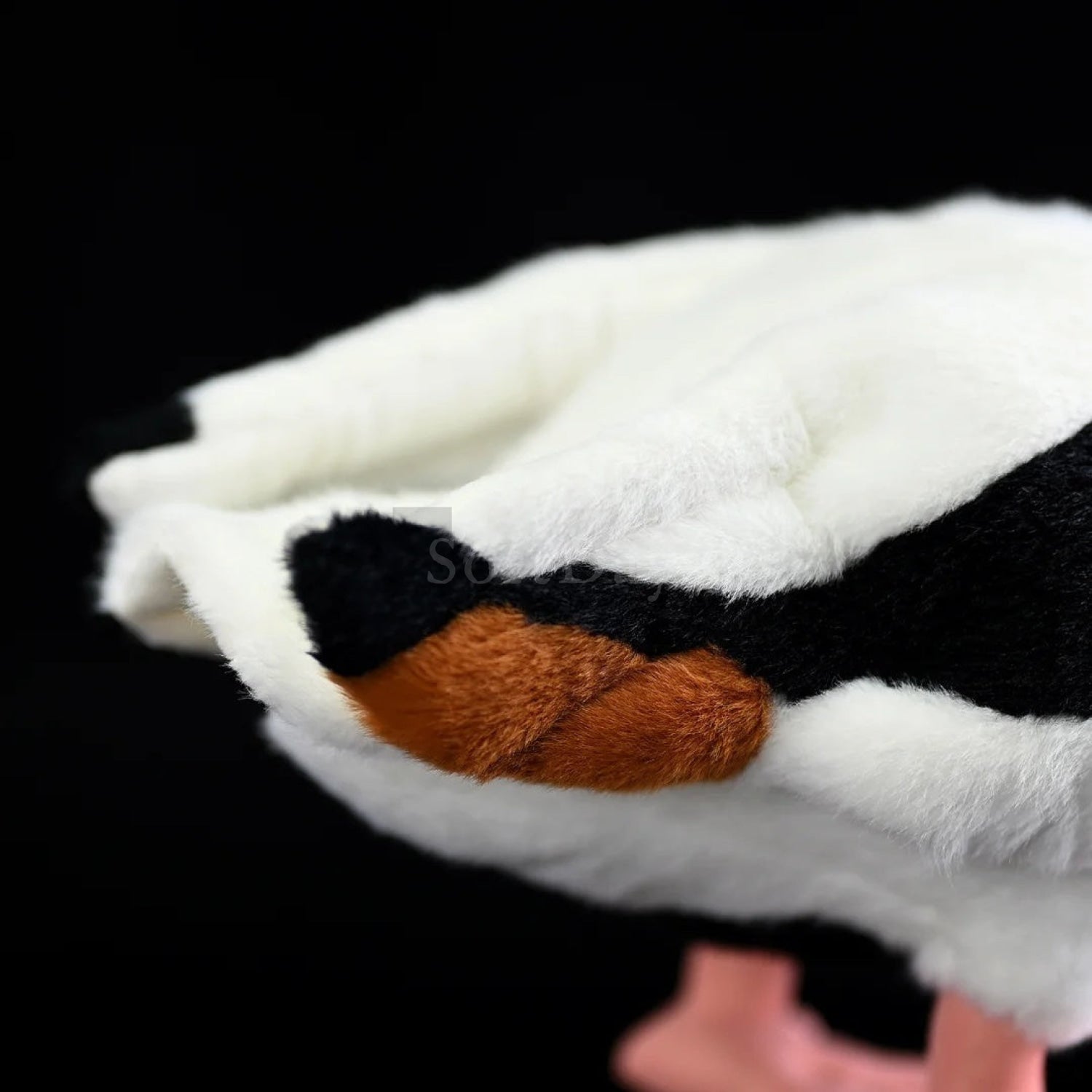 Fluffy tail of common shelduck plush toy, featuring soft materials and realistic orange and black details