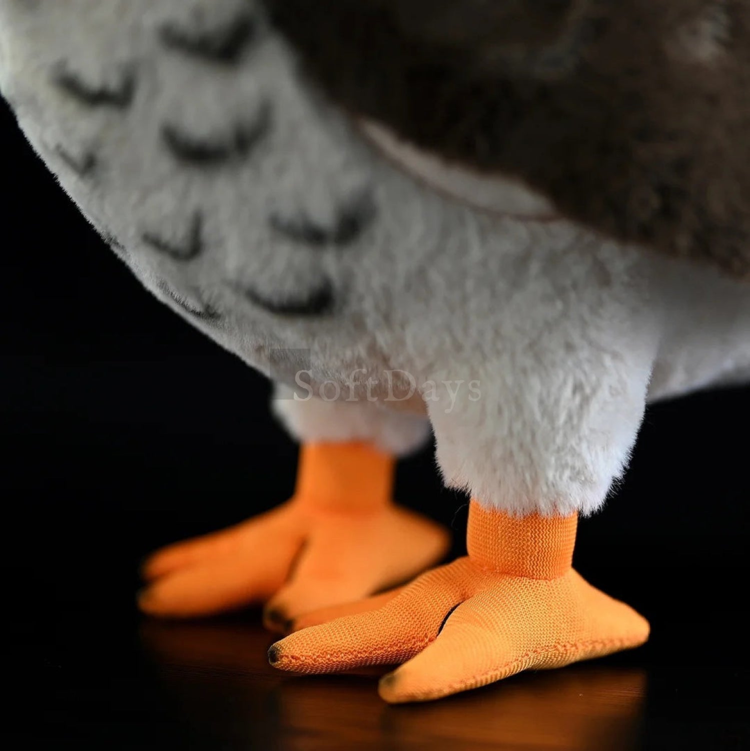Detailed orange talons of lifelike peregrine falcon plush toy, showcasing realistic craftsmanship