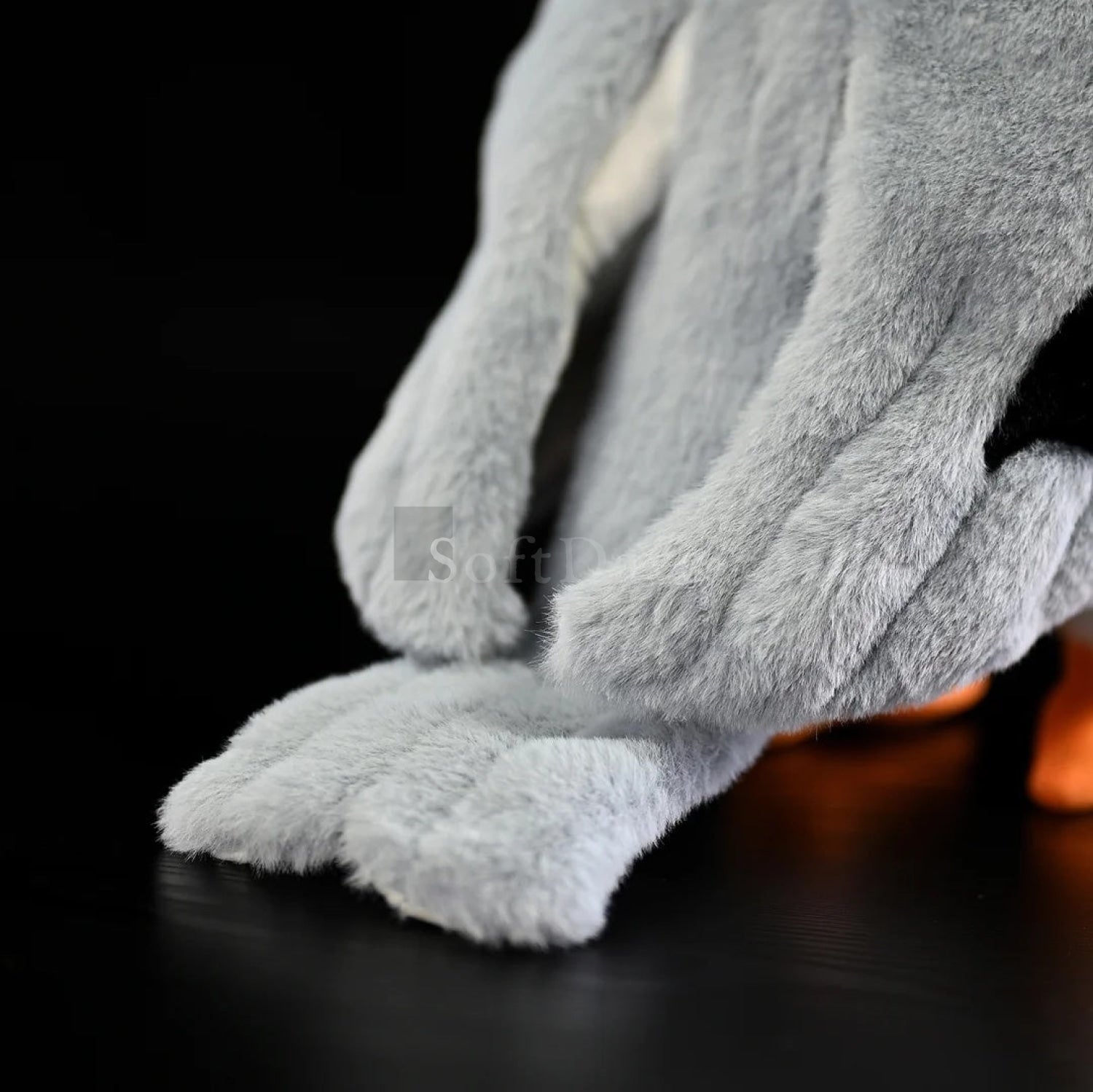 Close-up of black-winged kite plush toy’s soft grey tail feathers with realistic texture