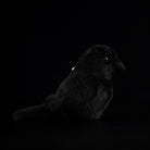 Left-side view of a charming carrion crow plush toy, showcasing its fluffy texture and cute shape