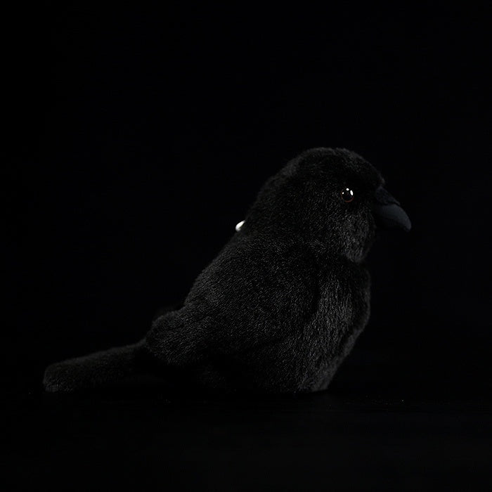 Left-side view of a charming carrion crow plush toy, showcasing its fluffy texture and cute shape