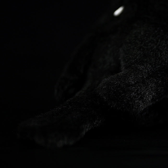 Close-up of the carrion crow plush toy’s tail, emphasizing its high-quality craftsmanship