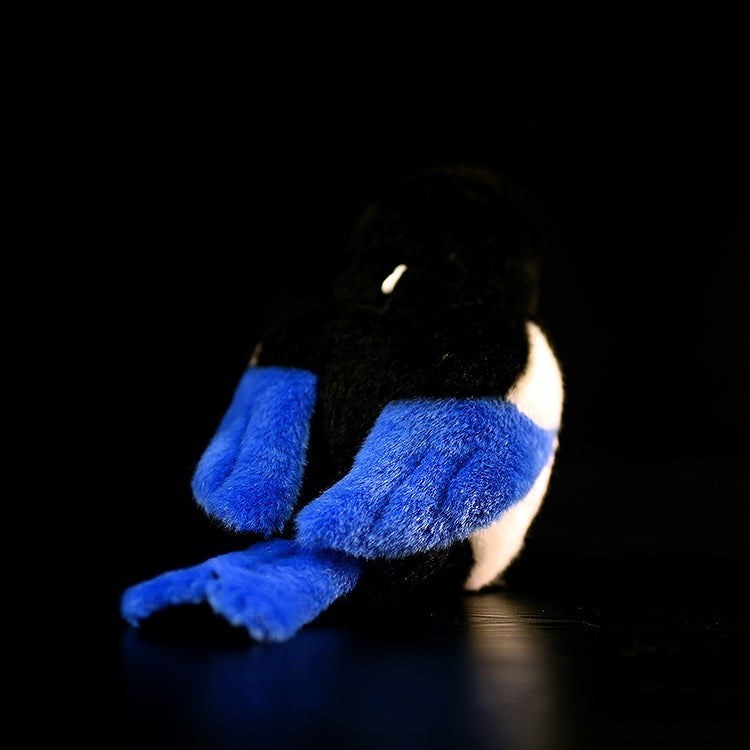 Back view of a black-billed magpie plush toy, highlighting its vibrant blue tail and lifelike craftsmanship
