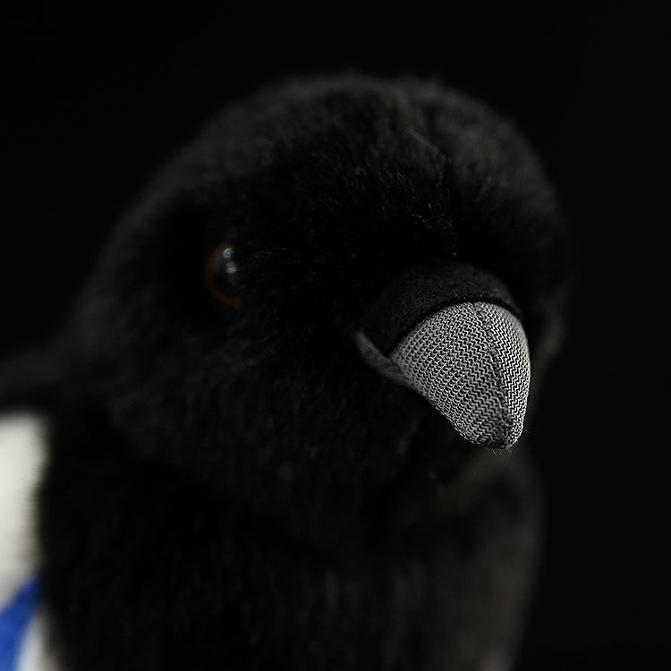Close-up of the black-billed magpie plush toy's beak, highlighting its realistic texture and authentic design