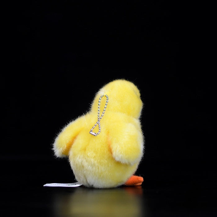 Back view of a soft yellow chick plush toy with a chain for use as a keychain or bag accessory