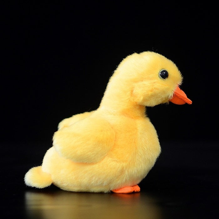 Side view of Pekin Duckling Plush Toy, highlighting its realistic shape and soft yellow plush