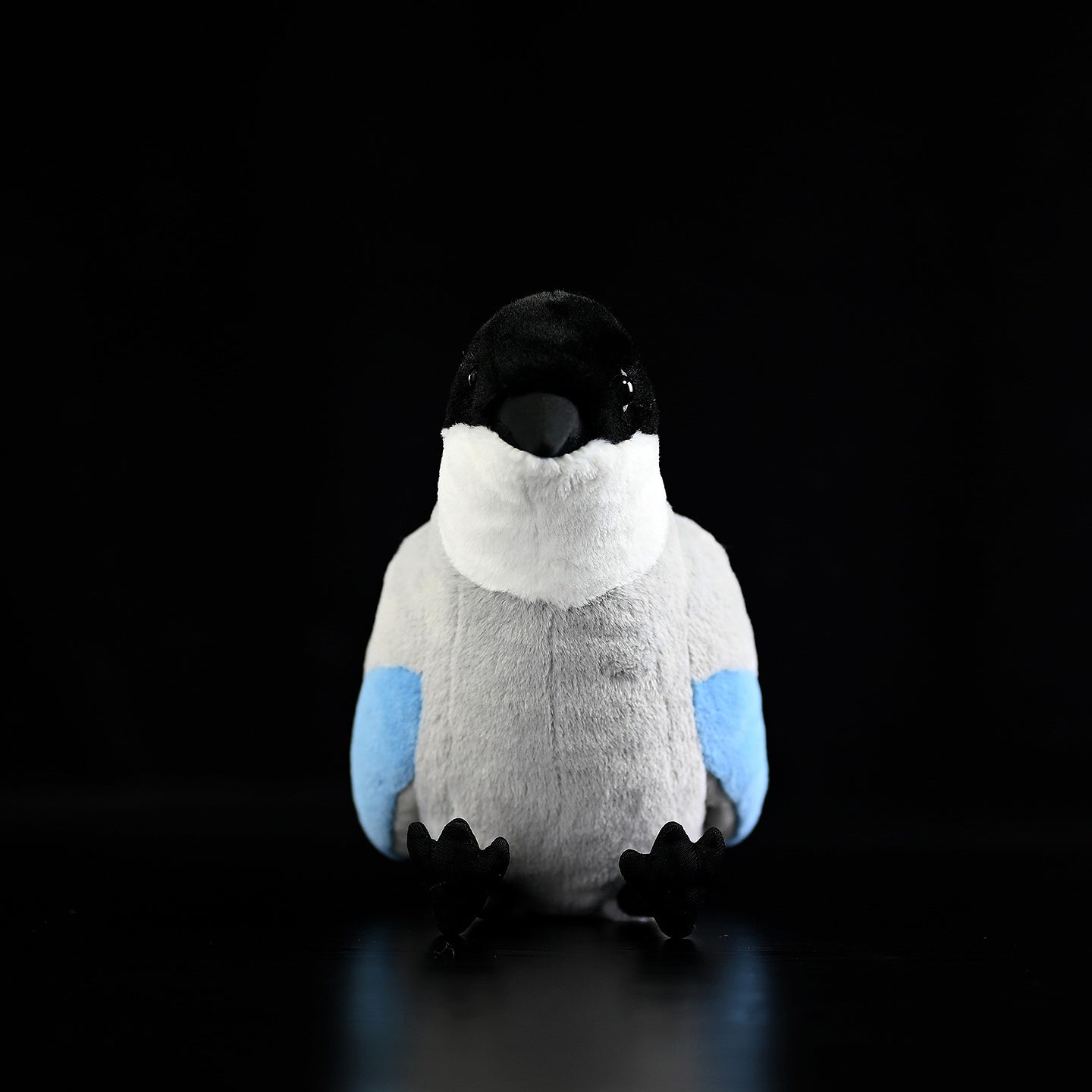 Sitting azure-winged magpie stuffed toy with soft blue wings and plush texture