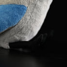 Close-up of the azure-winged magpie plush toy’s soft blue wing and fabric texture