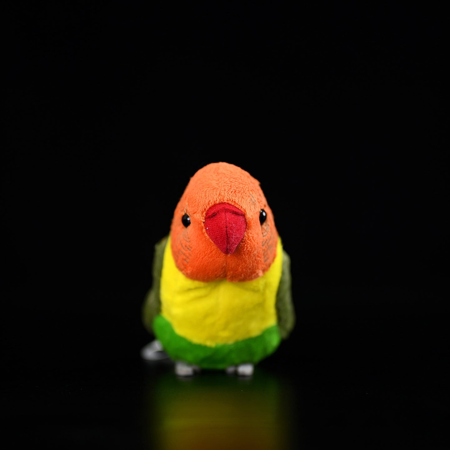Front view of a colorful Lilian's lovebird stuffed toy with realistic orange and green details