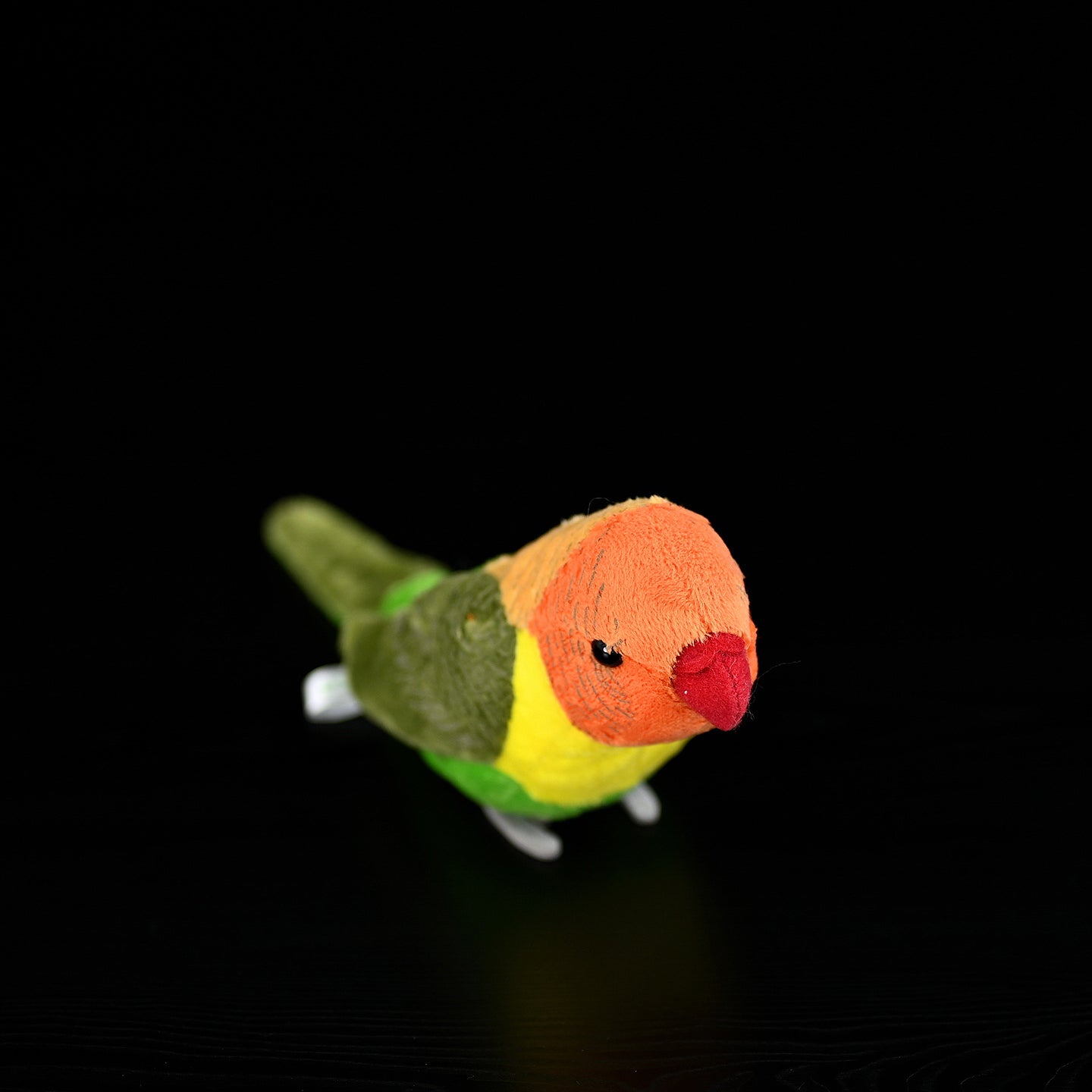 Top-down view of a Lilian's lovebird plush toy, perfect for bird-themed decor or gifts