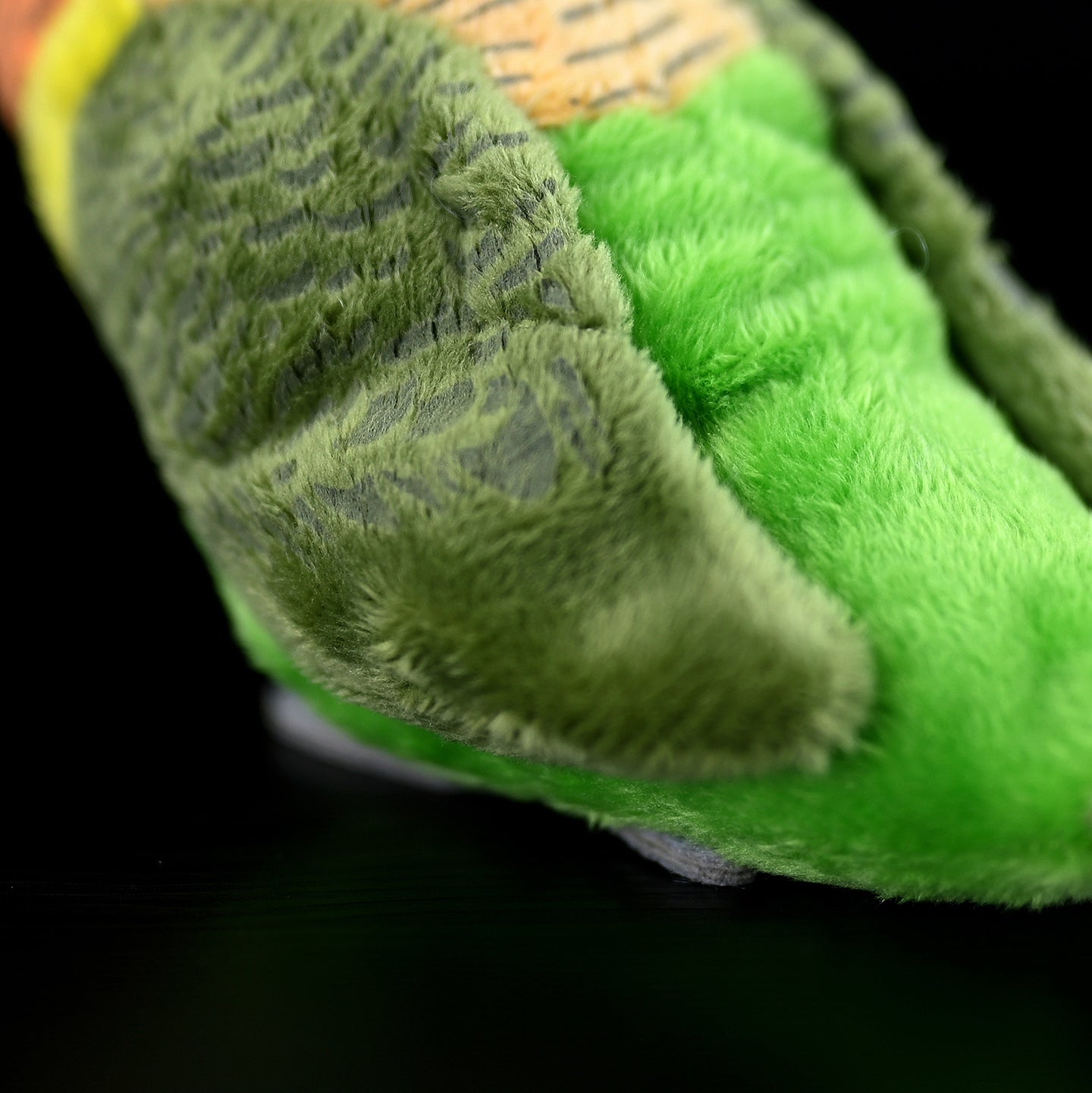 Close-up of soft green wing textures on the Lilian's lovebird stuffed animal, perfect for bird enthusiasts