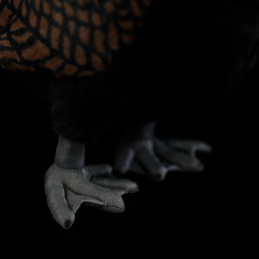 Close-up of the feet on a Great Cormorant plush toy, featuring realistic textures and fine details