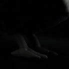 Close-up of the feet on a Collared Crow plush toy, featuring detailed texture and lifelike design