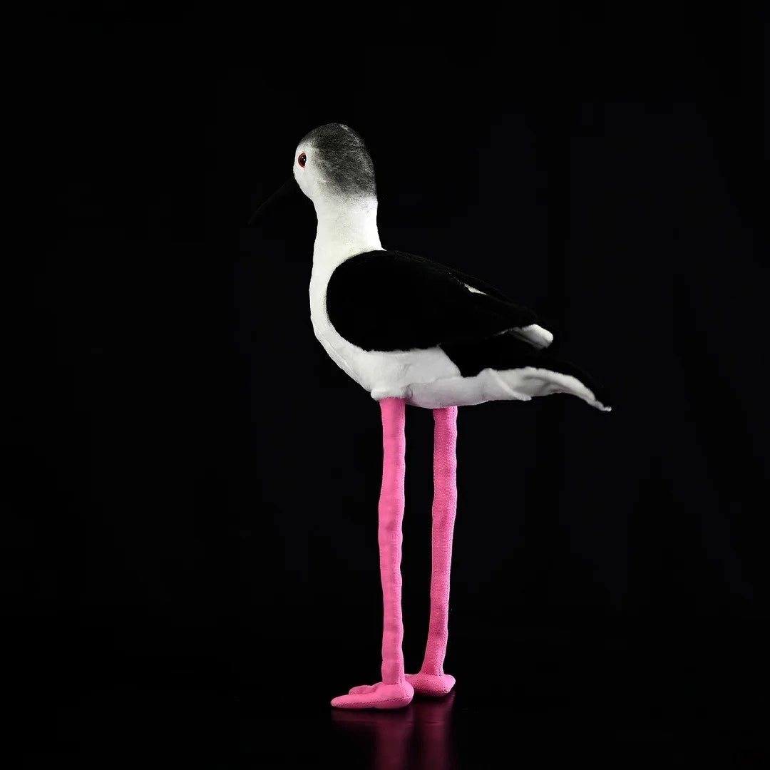 Side profile of the Black-winged Stilt plush toy, highlighting its iconic long pink legs and elegant shape