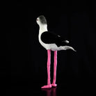 Side profile of the Black-winged Stilt plush toy, highlighting its iconic long pink legs and elegant shape