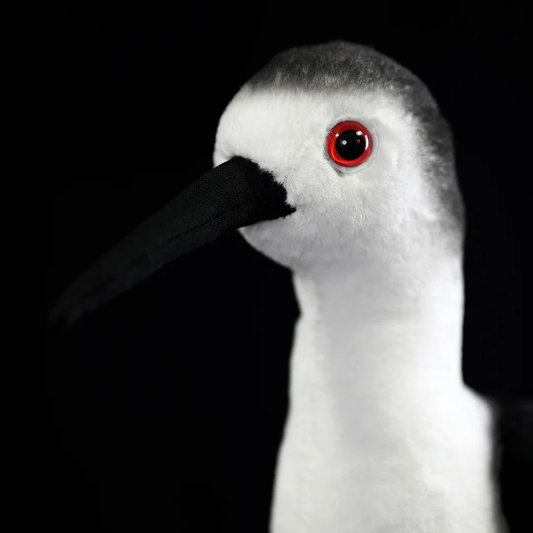 Detailed view of the Black-winged Stilt plush toy's red eyes and black beak, capturing its realistic look