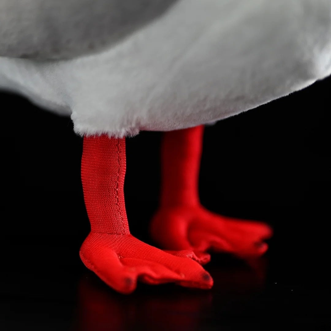 Focused view of the Black-headed Gull plush's red legs and webbed feet, designed for realism