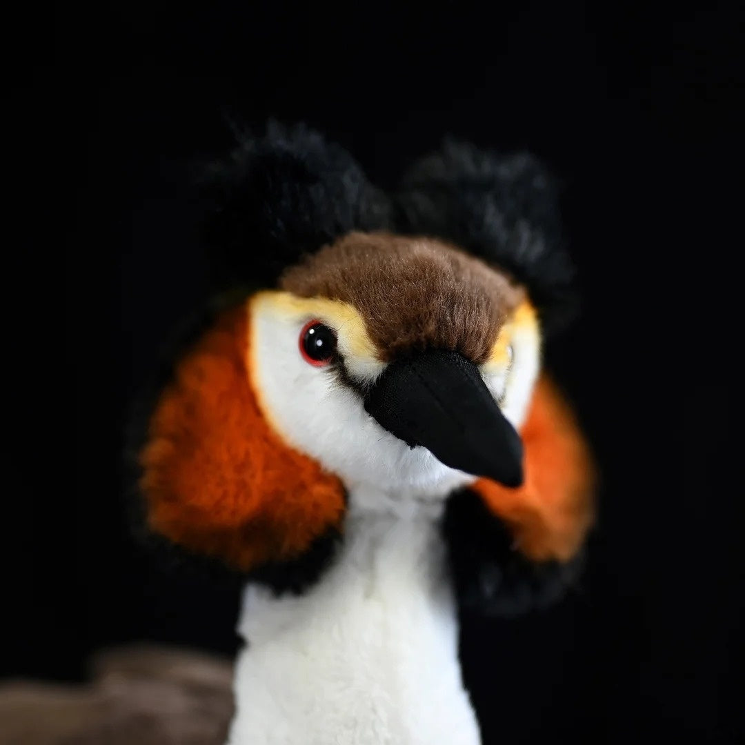 Close-up of Great Crested Grebe plush's head, featuring detailed crest and orange-brown cheeks