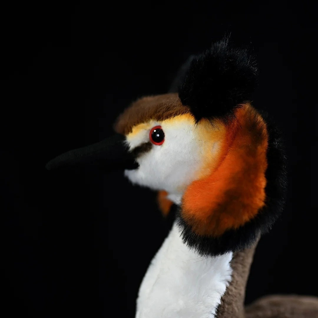 Side view of Great Crested Grebe plush head, showcasing realistic features and soft textures