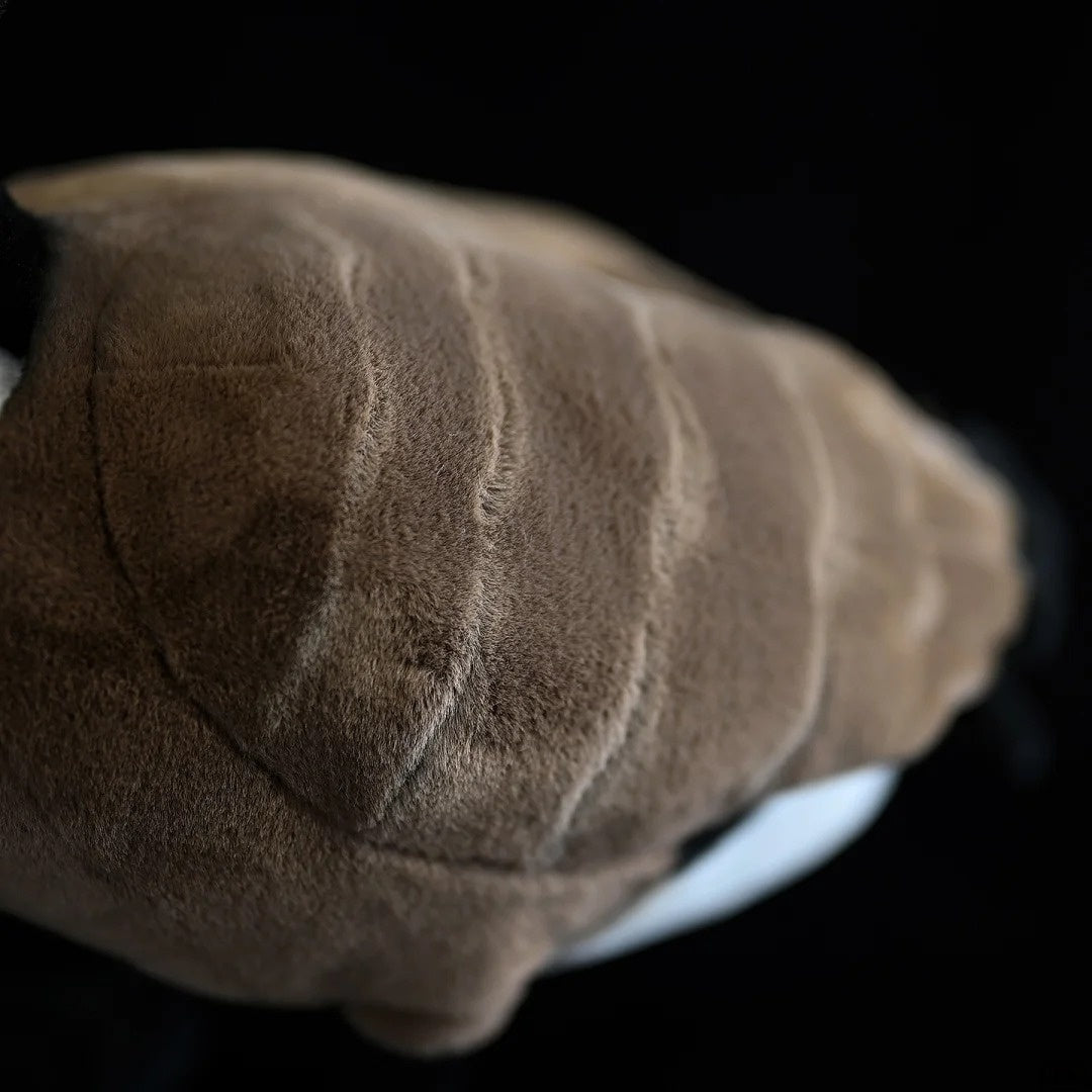Focus on the feather detail of a Canada Goose stuffed animal, showcasing high-quality craftsmanship