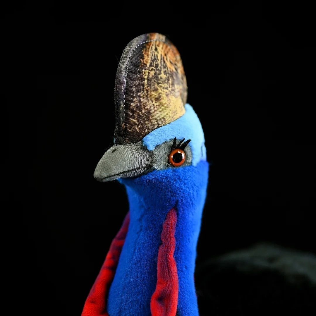 Close-up of a Southern Cassowary plush toy’s detailed head and colorful casque design