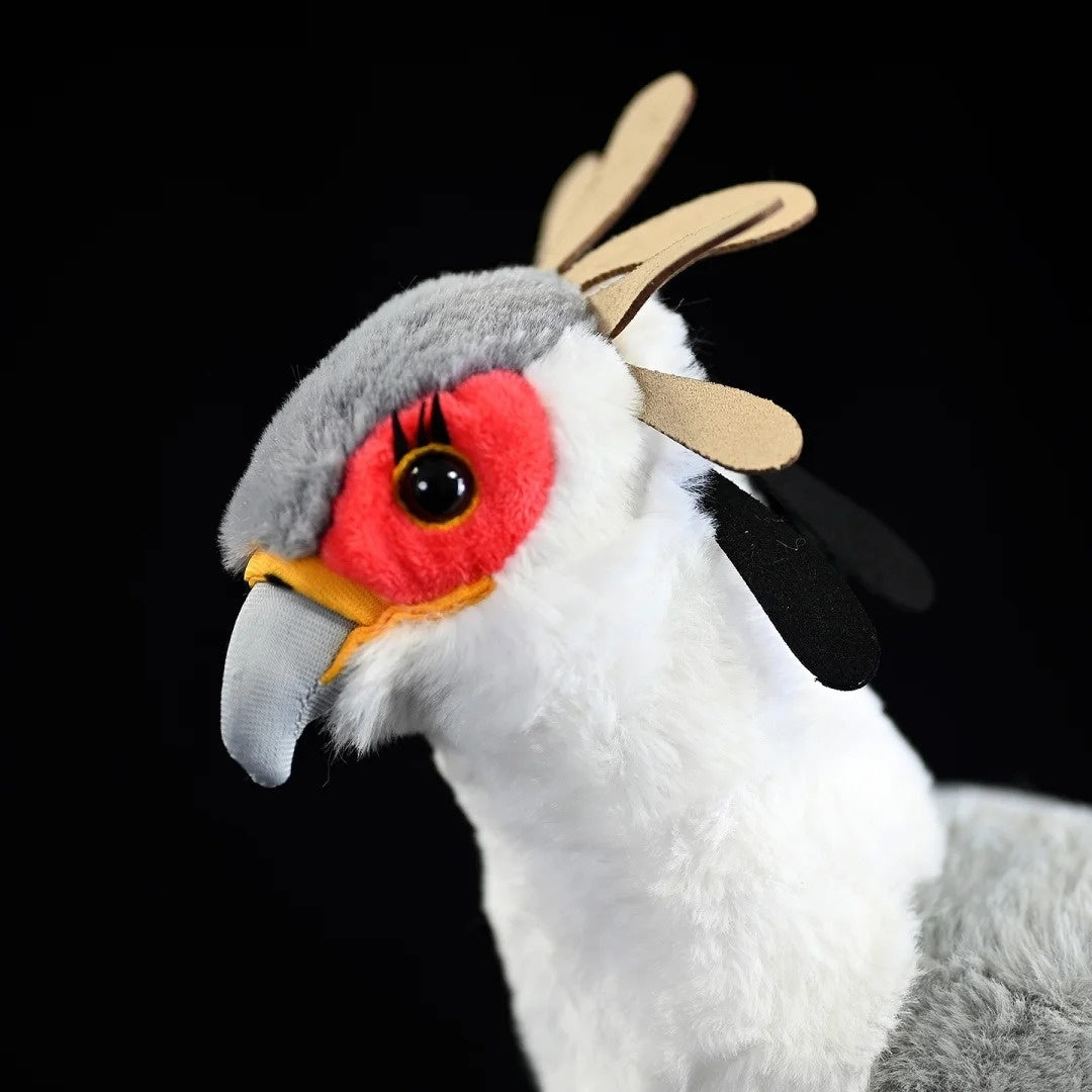 Close-up of Secretarybird plush toy head, showing vibrant red face and crest feathers for a realistic touch
