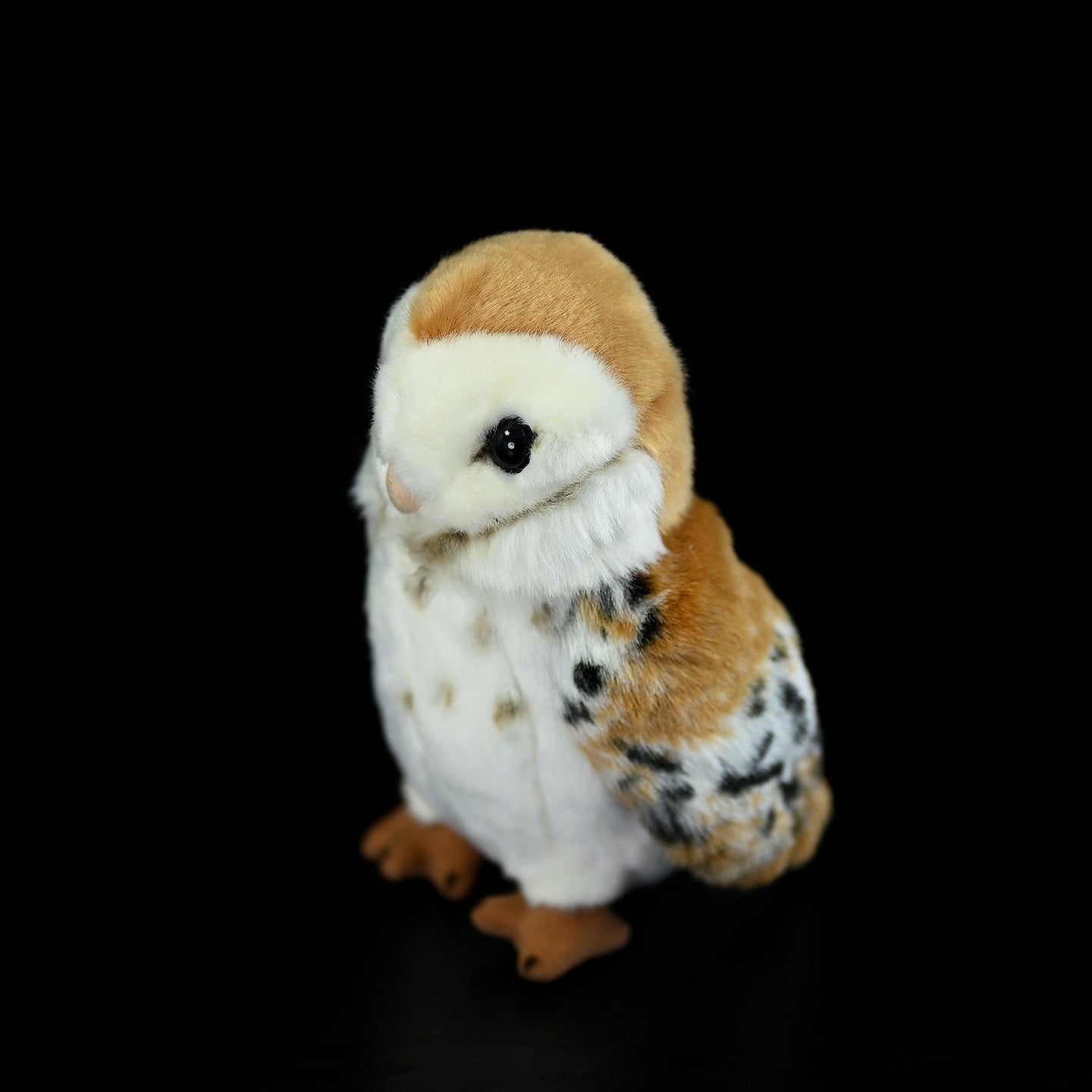 Side overhead view of the Barn Owl Plush Toy with lifelike details and soft fabric, a perfect gift for bird lovers and collectors