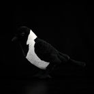 Side profile of a lifelike Daurian Jackdaw plush toy featuring authentic design and soft texture