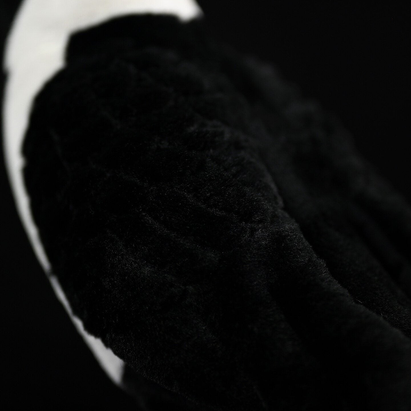 Detailed texture view of the Daurian Jackdaw plush, showcasing its soft black feathers for a lifelike feel