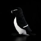Side view of a realistic Razorbill plush by SoftDaysLab®, showcasing its sleek black and white design