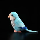 Side profile of a Blue Quaker Parrot plush toy by SoftDaysLab®, showcasing lifelike blue feathers and detailed design